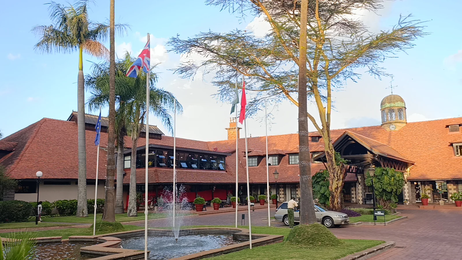 A landscaped conference setting with flagpoles